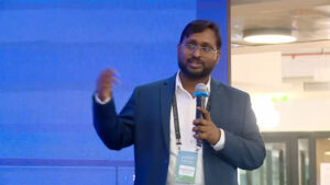 Amit Singhee (IBM) and Pankaj Singh (BharatGen) demo InstructLab AI legal access at People+ai Mela, showing multilingual Bharatiya Nyaya Samhita queries.